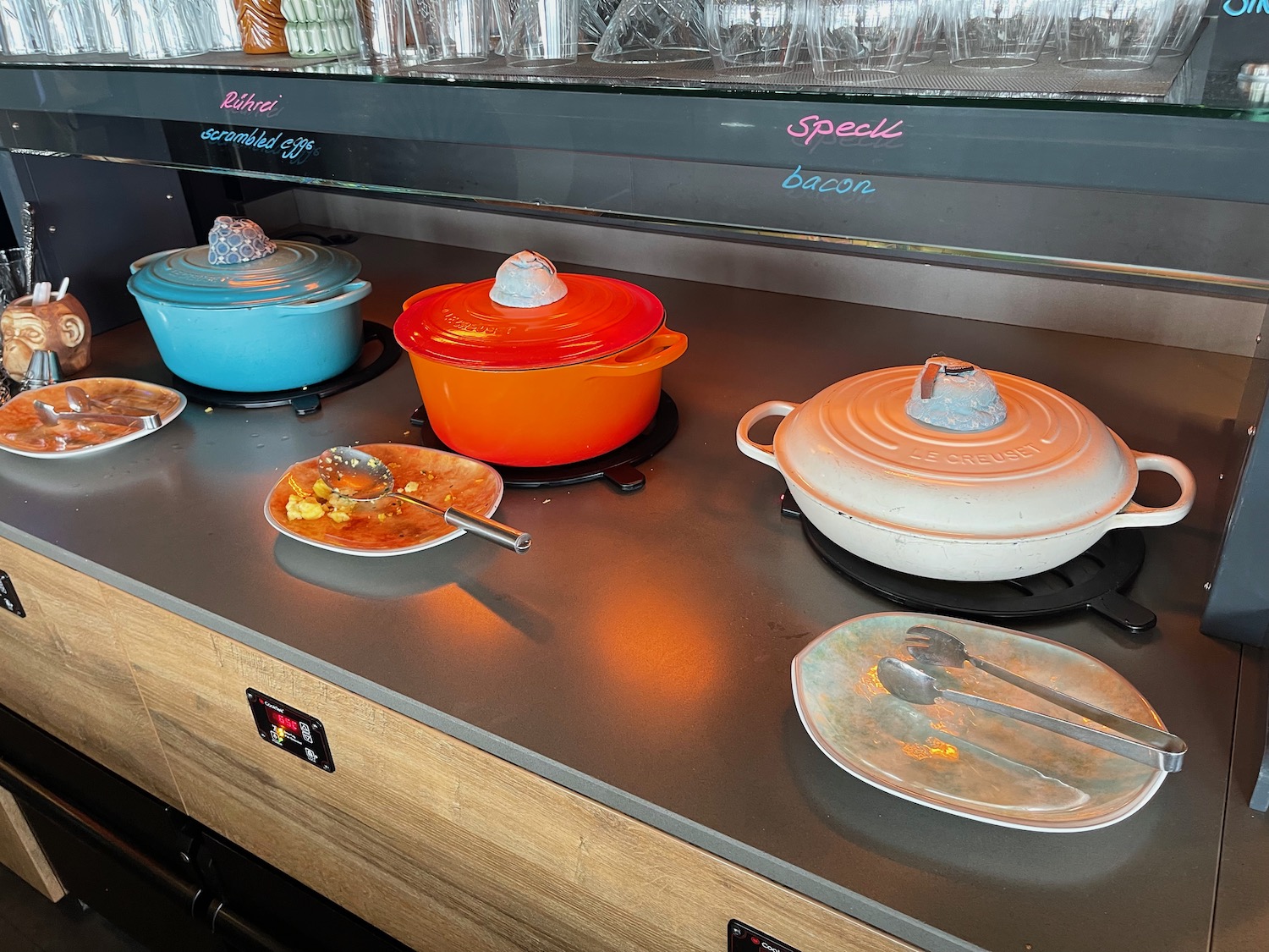 a counter with several pots and plates