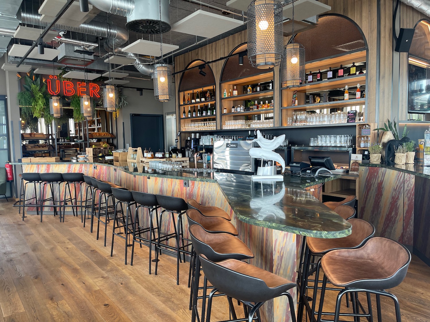 a bar with many chairs and a counter