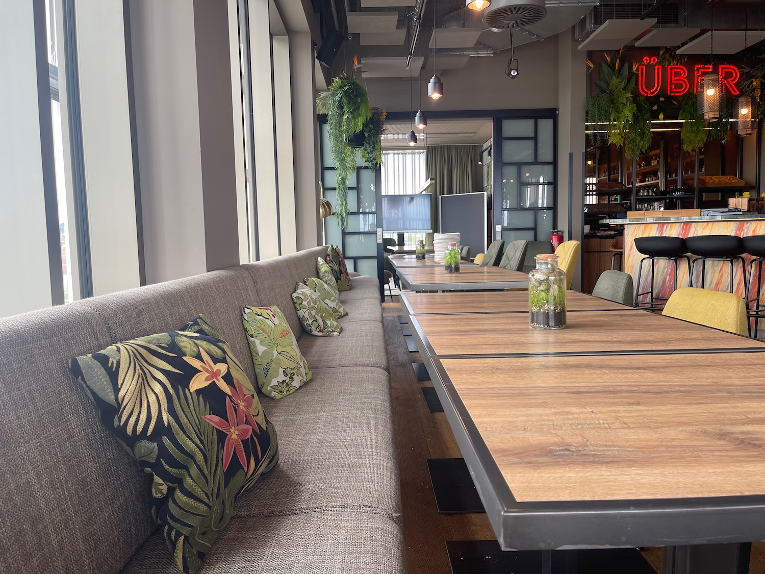 a long couch with pillows in a restaurant