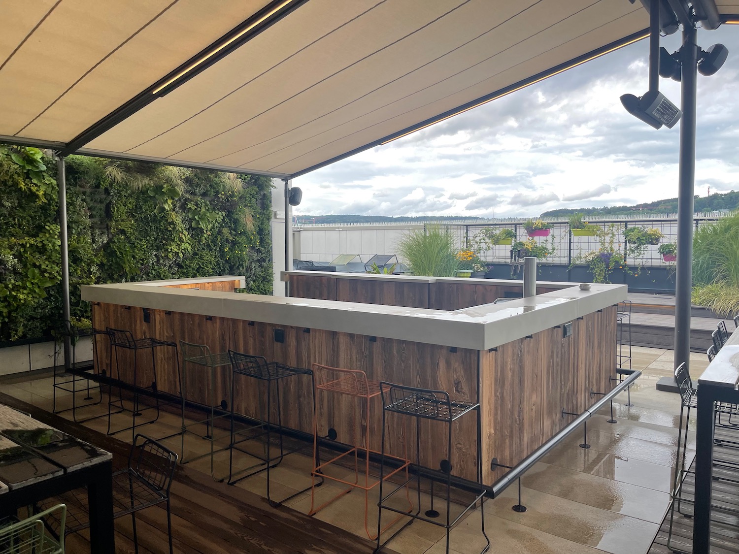 a wooden bar with chairs on a patio