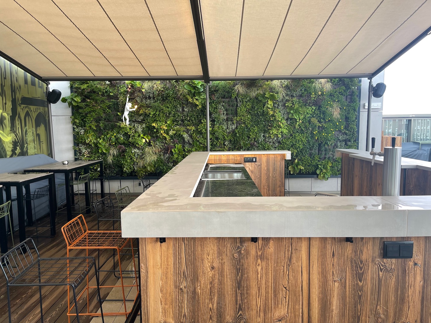 a patio with a bar and a wood deck