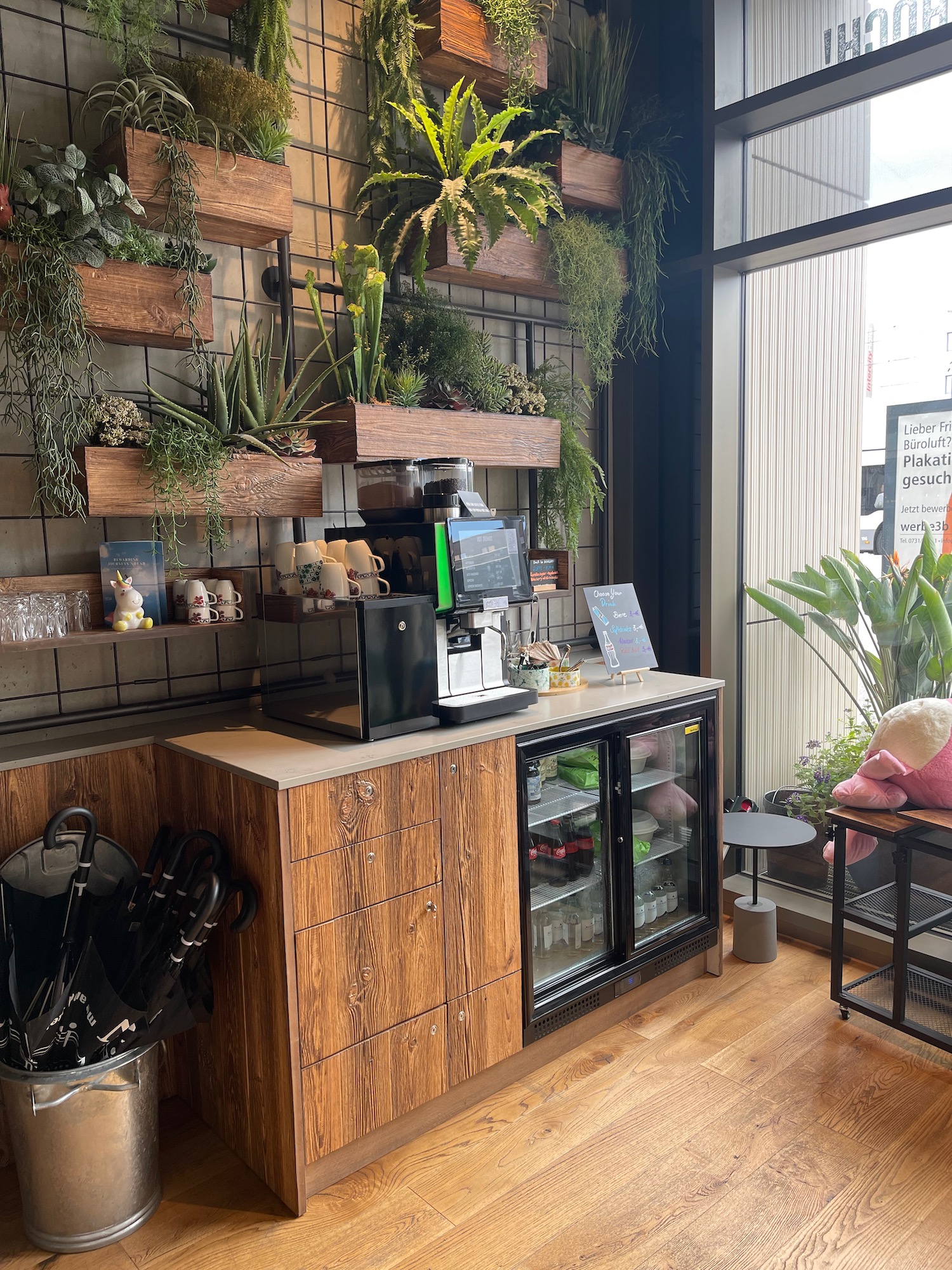 a coffee machine and a refrigerator with plants on the wall