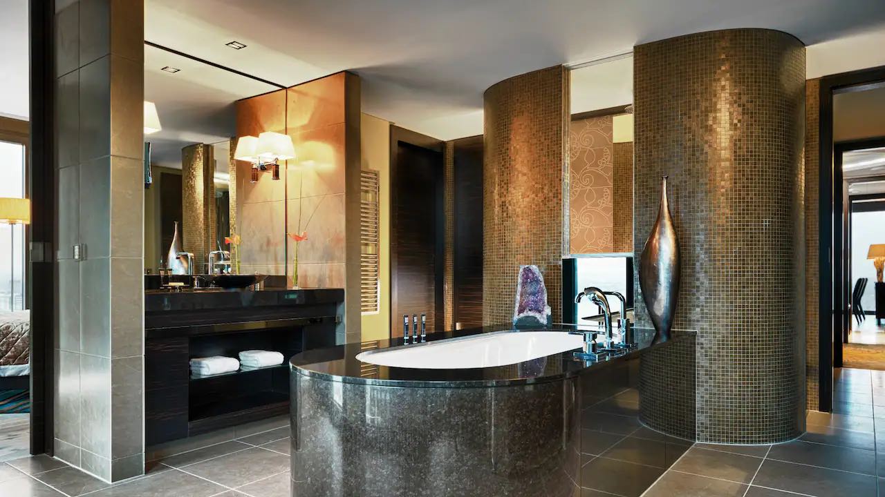 a bathroom with a large tub and a large mirror