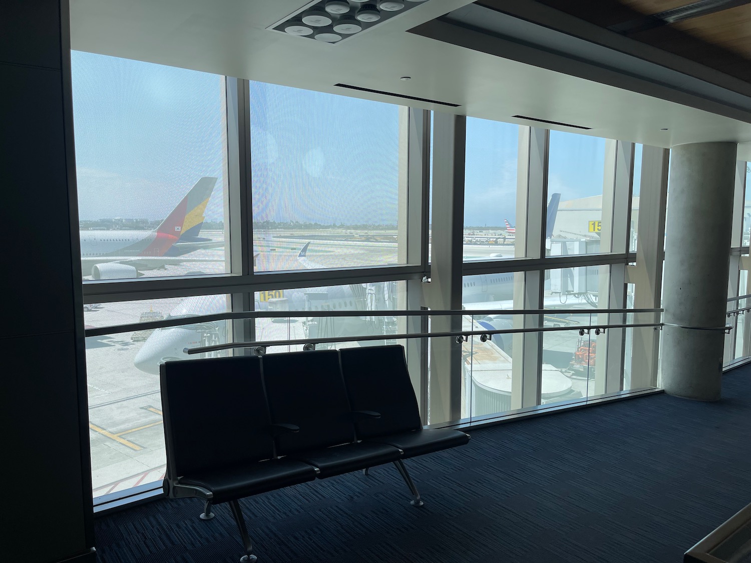 a seat in a room with windows and planes in the background