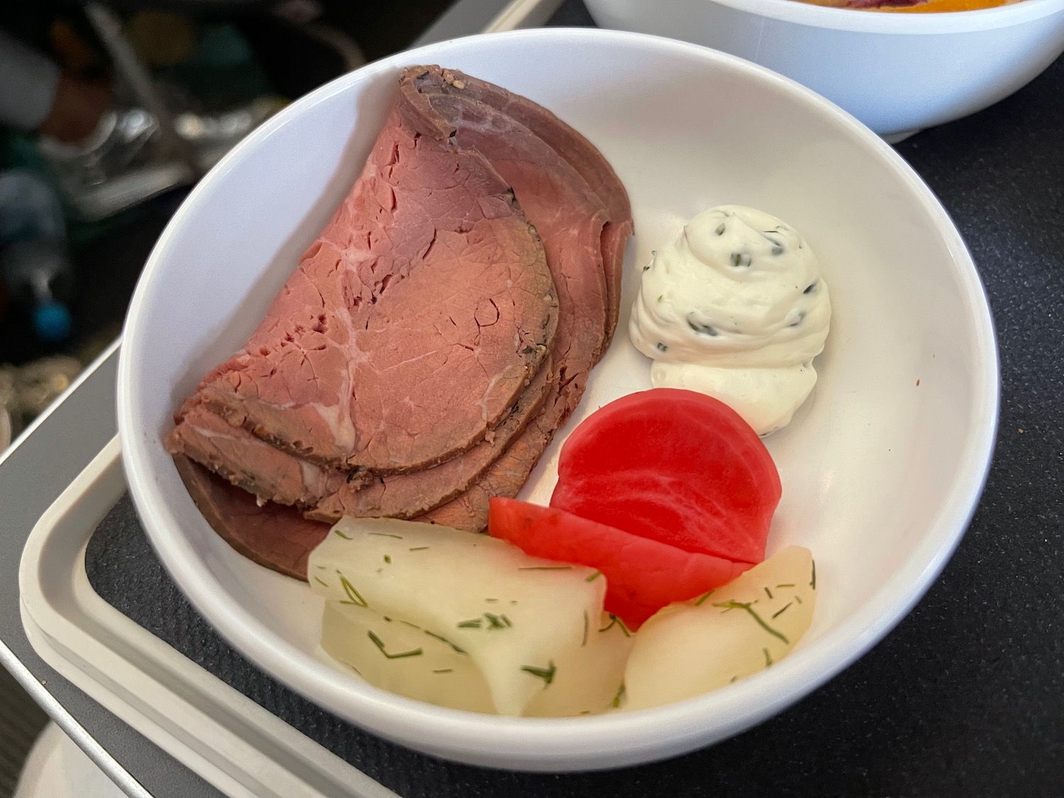 a bowl of food with meat and vegetables