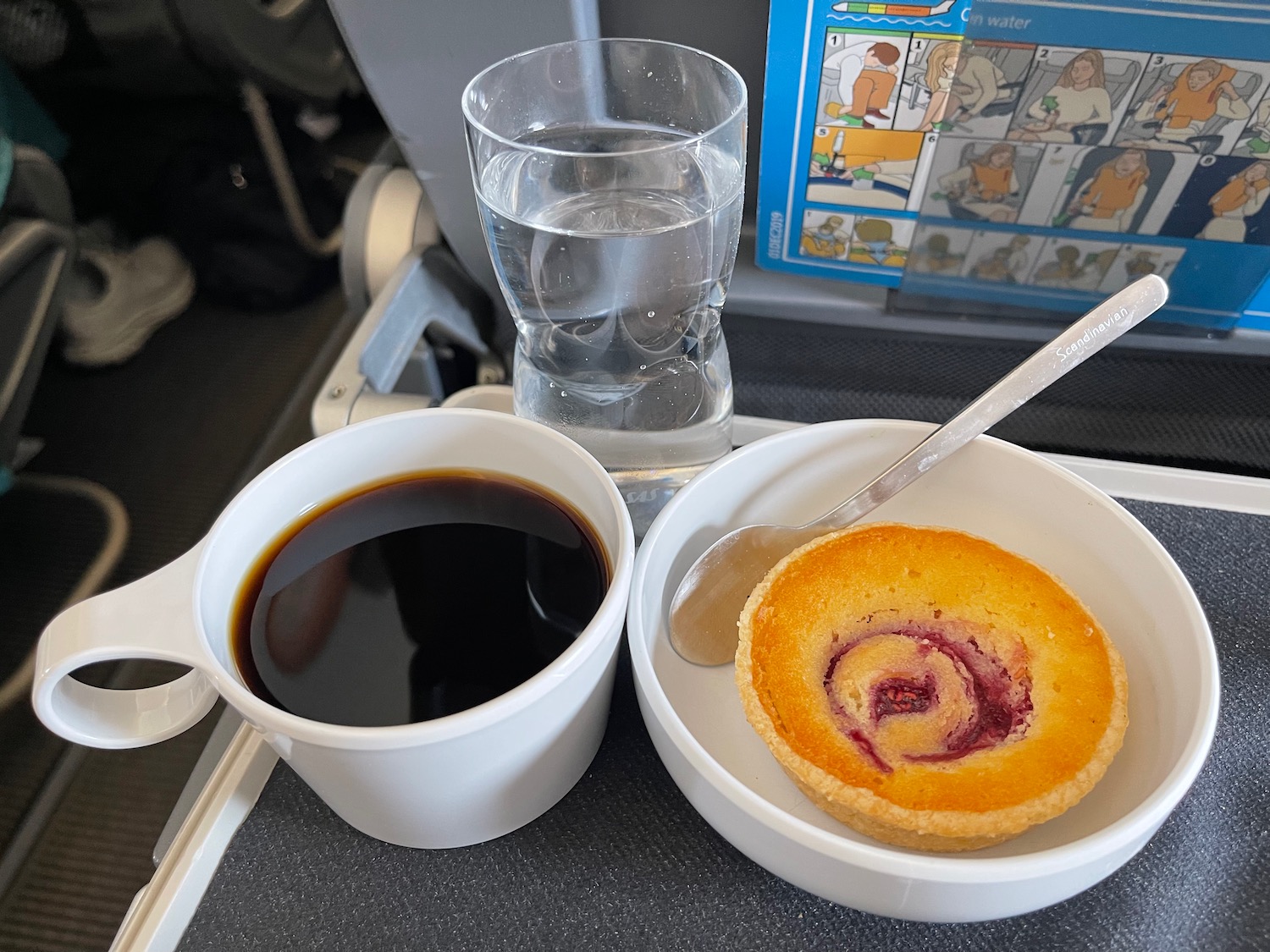 a cup of coffee and a pastry on a tray