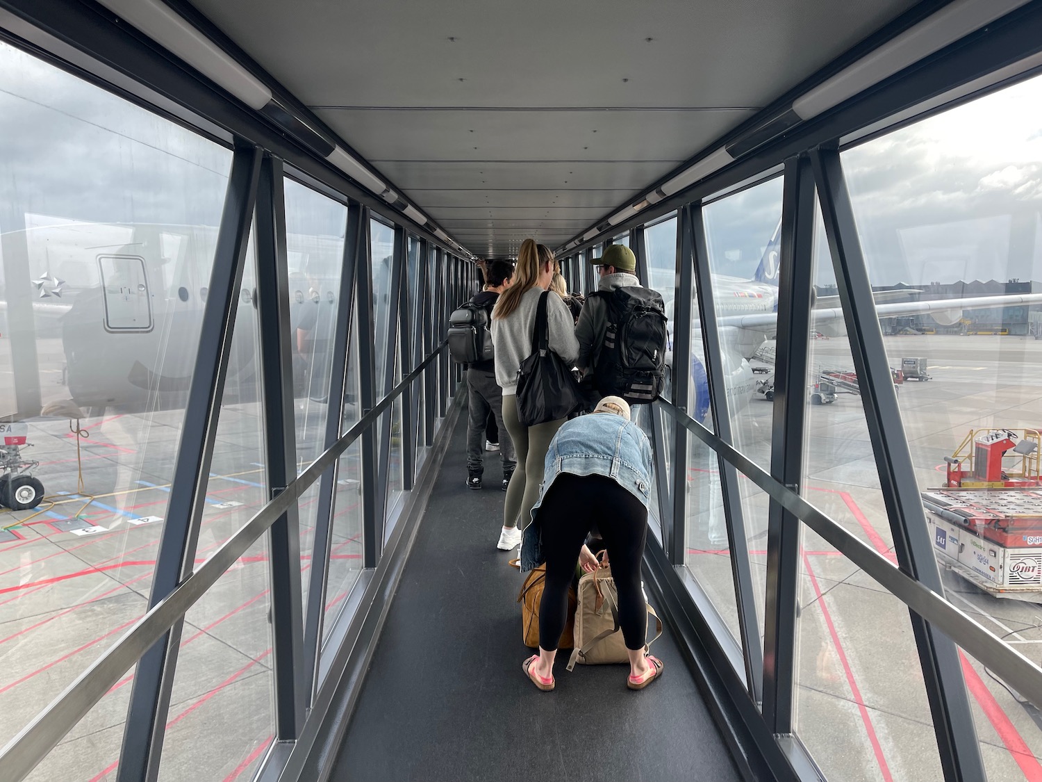 people standing on a walkway with luggage