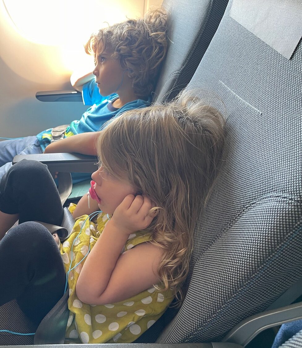 a couple of children sitting on chairs