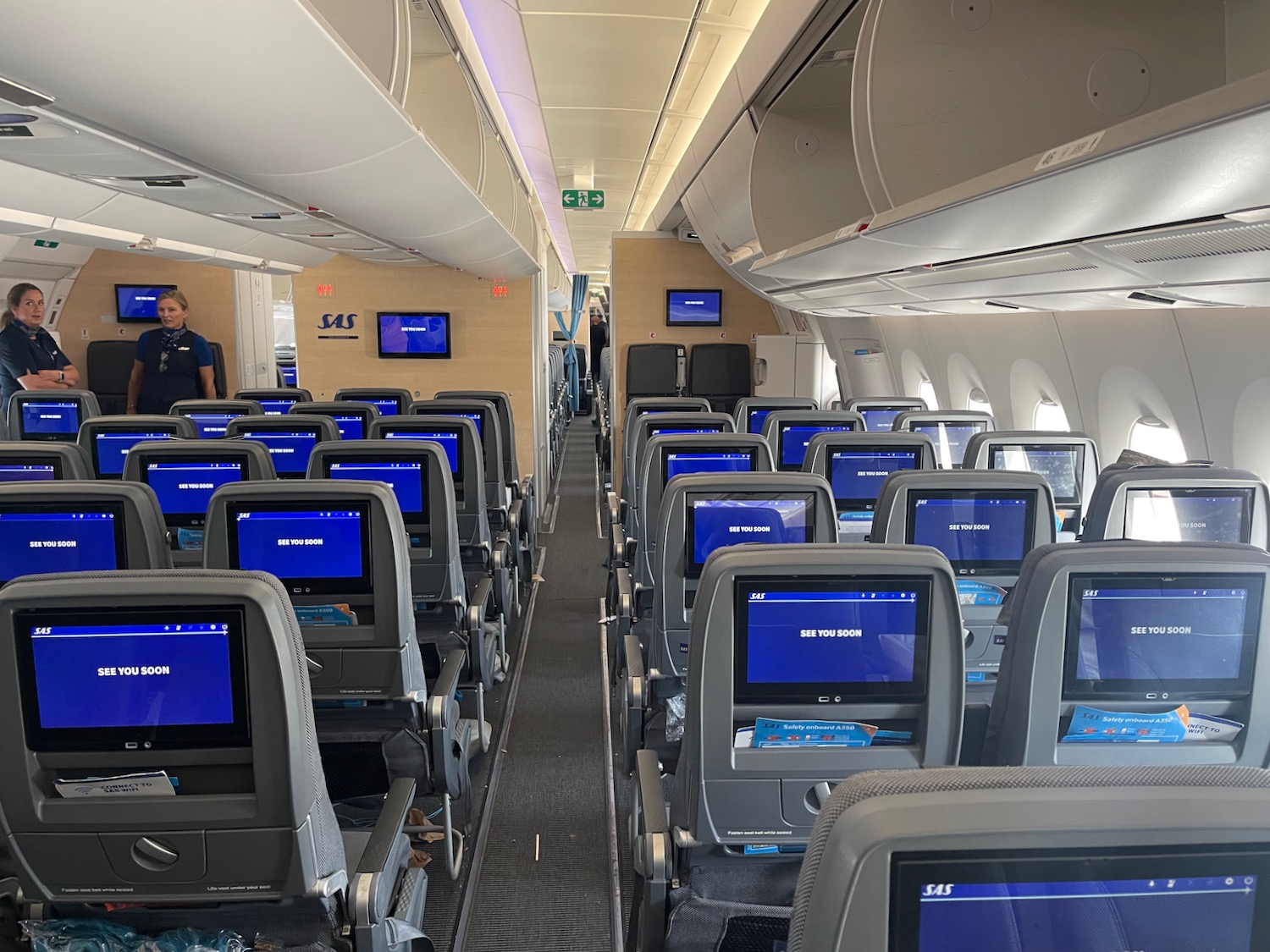 an airplane with rows of seats and monitors