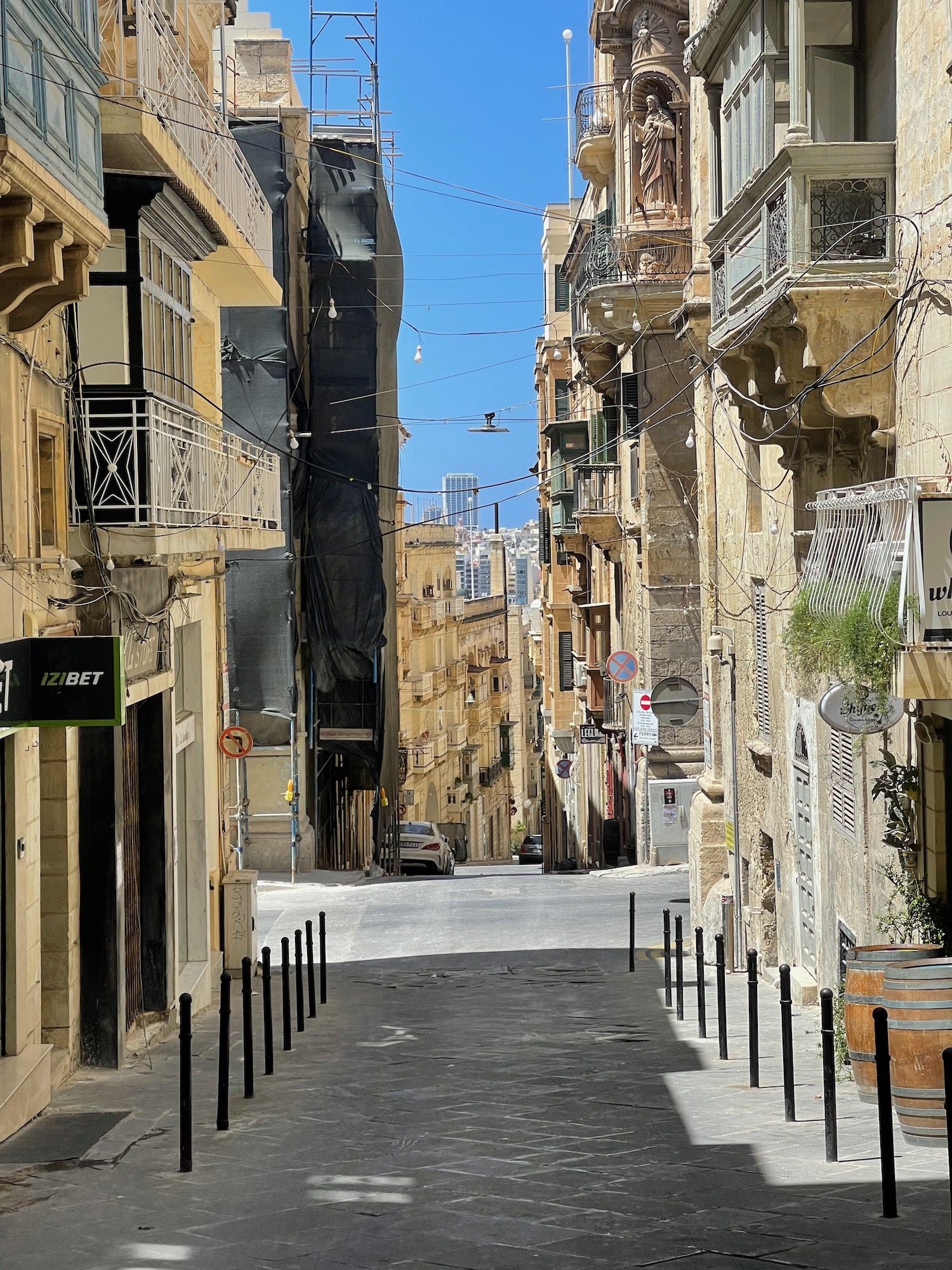 a street with buildings and cars on the side