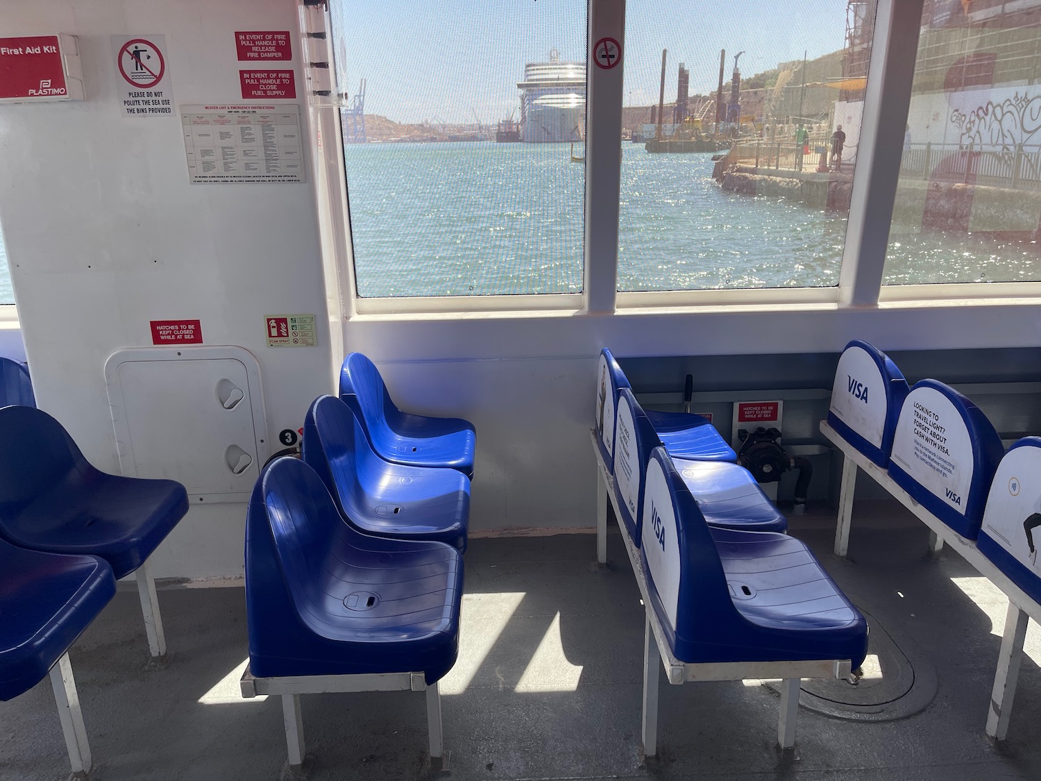 a row of blue chairs on a ferry