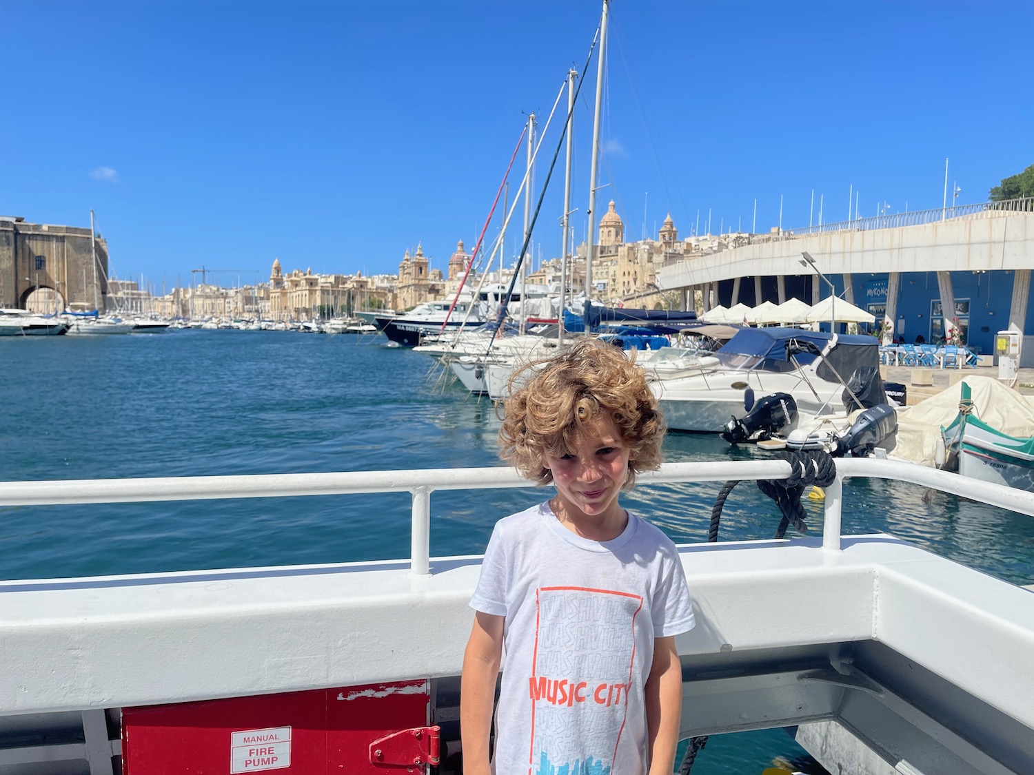 a boy standing on a boat
