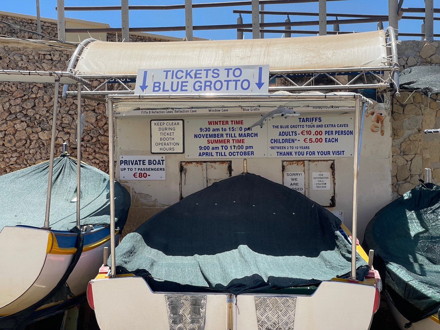 a boat with tarp cover and a sign