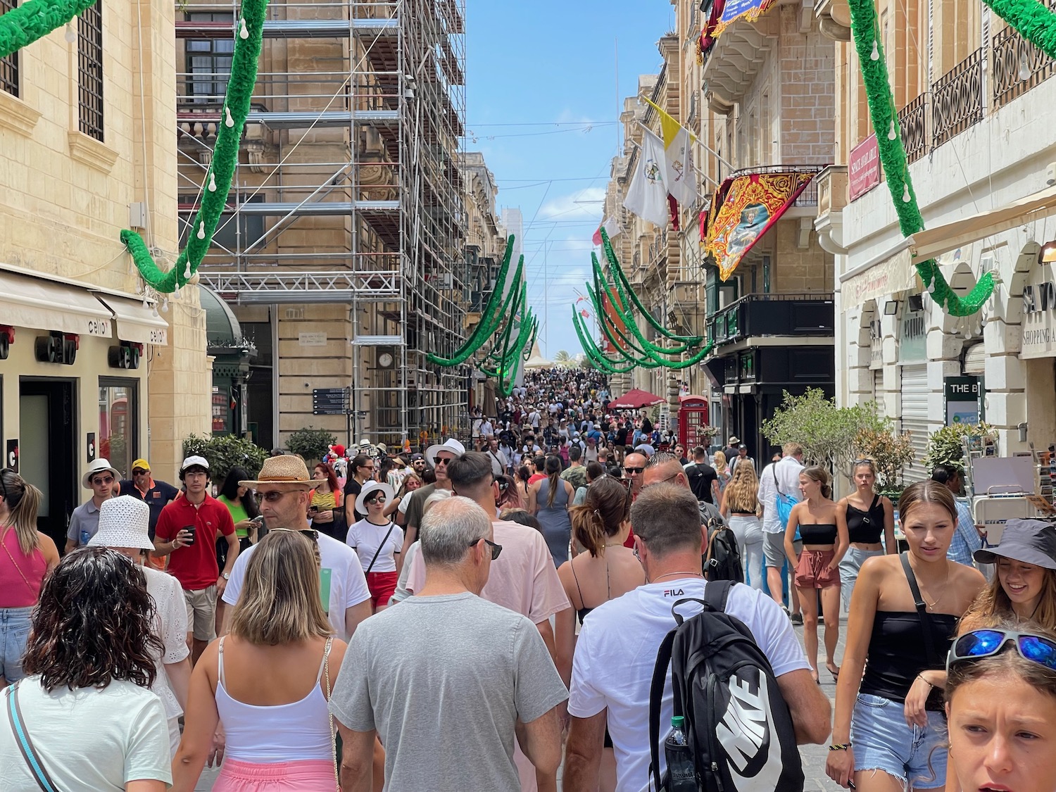 a crowd of people walking down a street