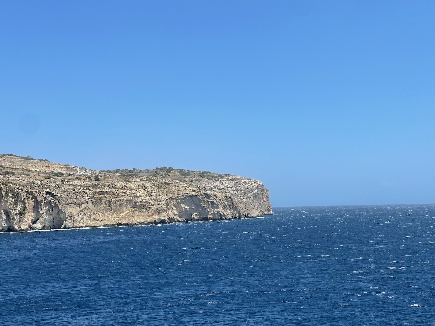 a rocky cliff above the water