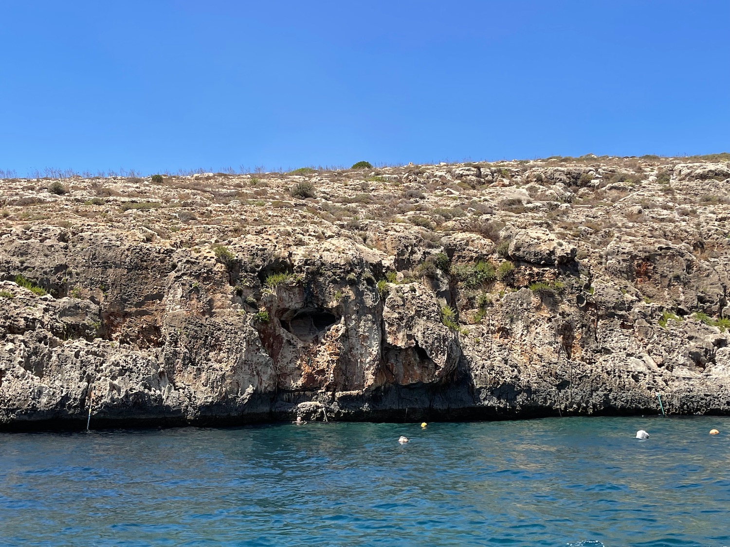 a rocky cliff above water