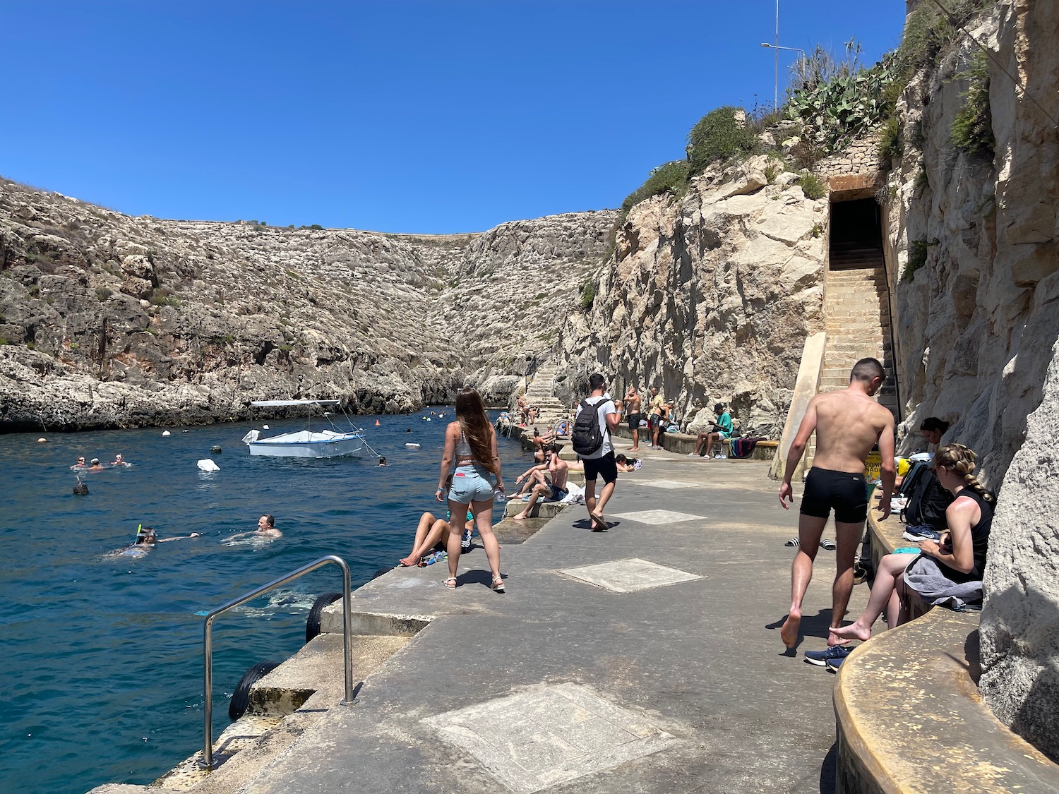 people on a path near a body of water