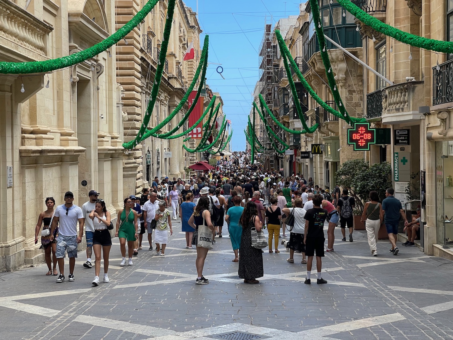 a crowd of people walking down a street