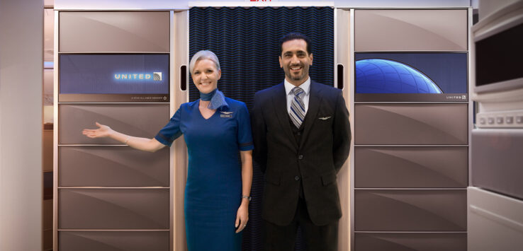 a man and woman standing in front of an exit door