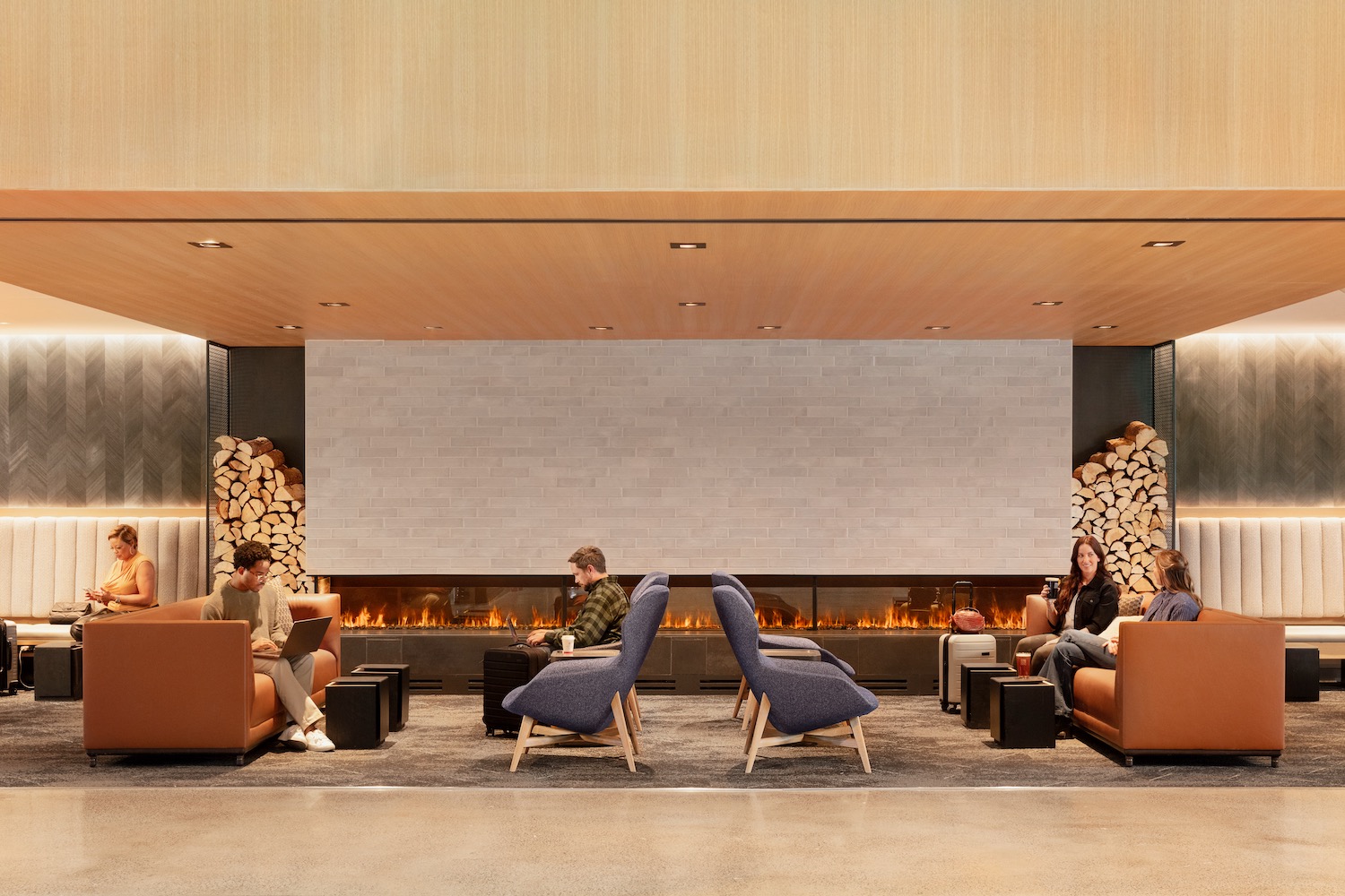 a group of people sitting in a room with a fireplace