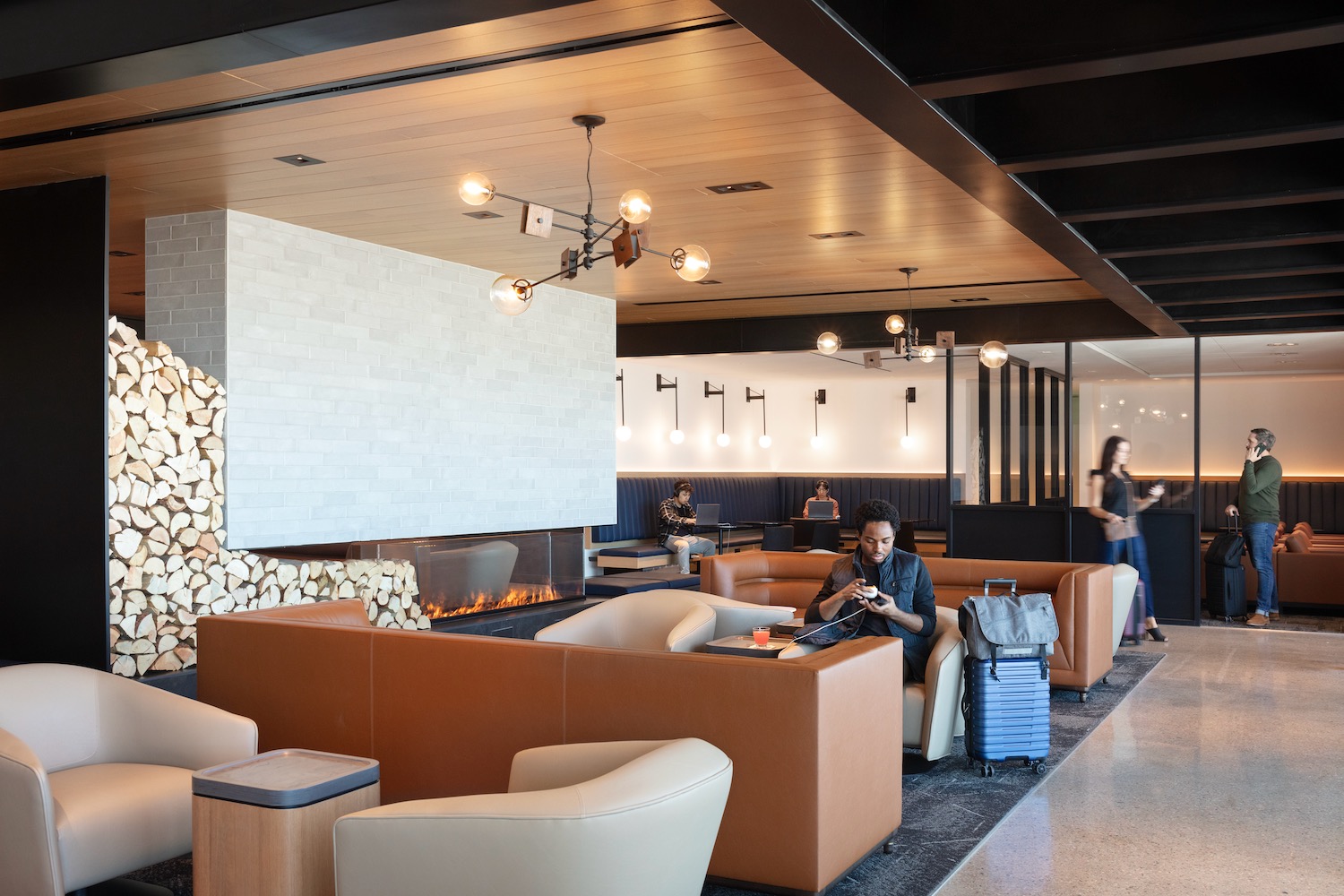 a man sitting in a lounge area with luggage