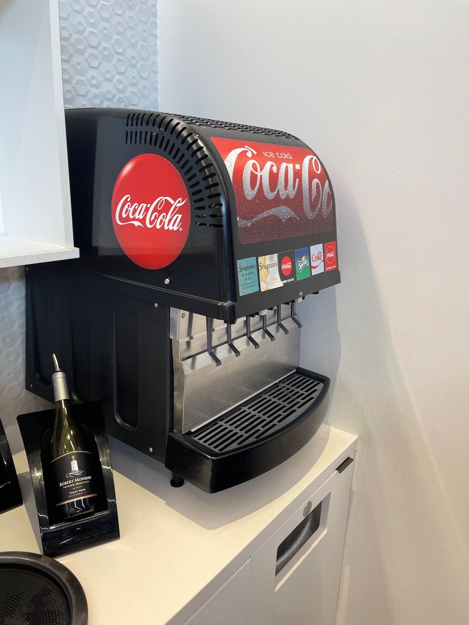 a soda machine with a bottle of wine
