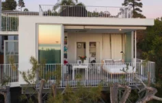 a white house with a balcony and a bed