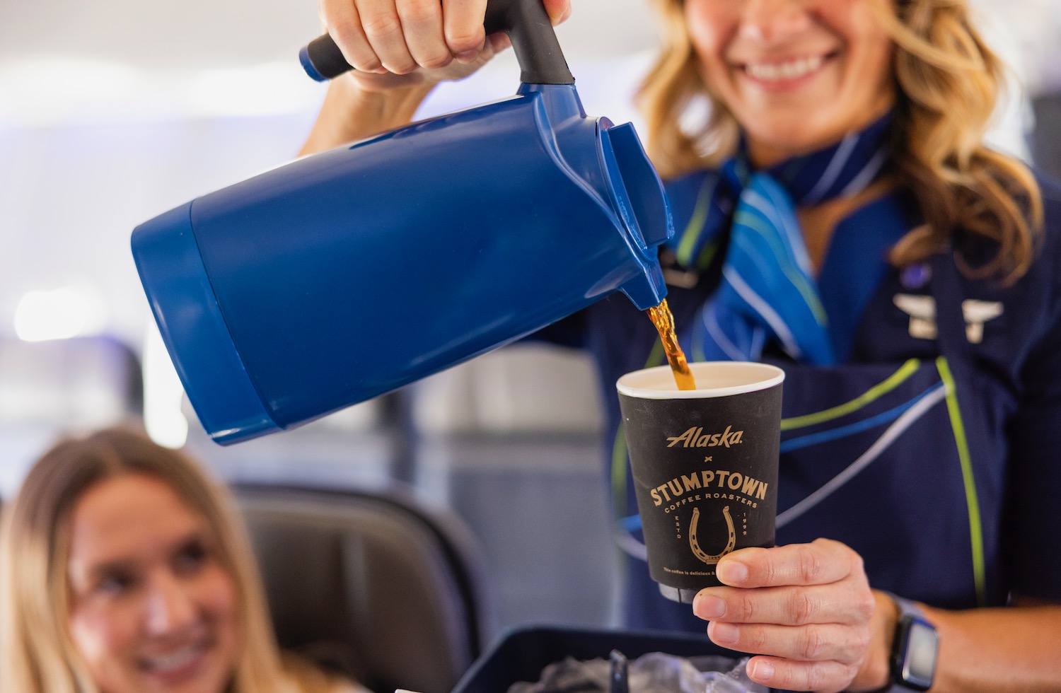 a woman pouring coffee into a cup