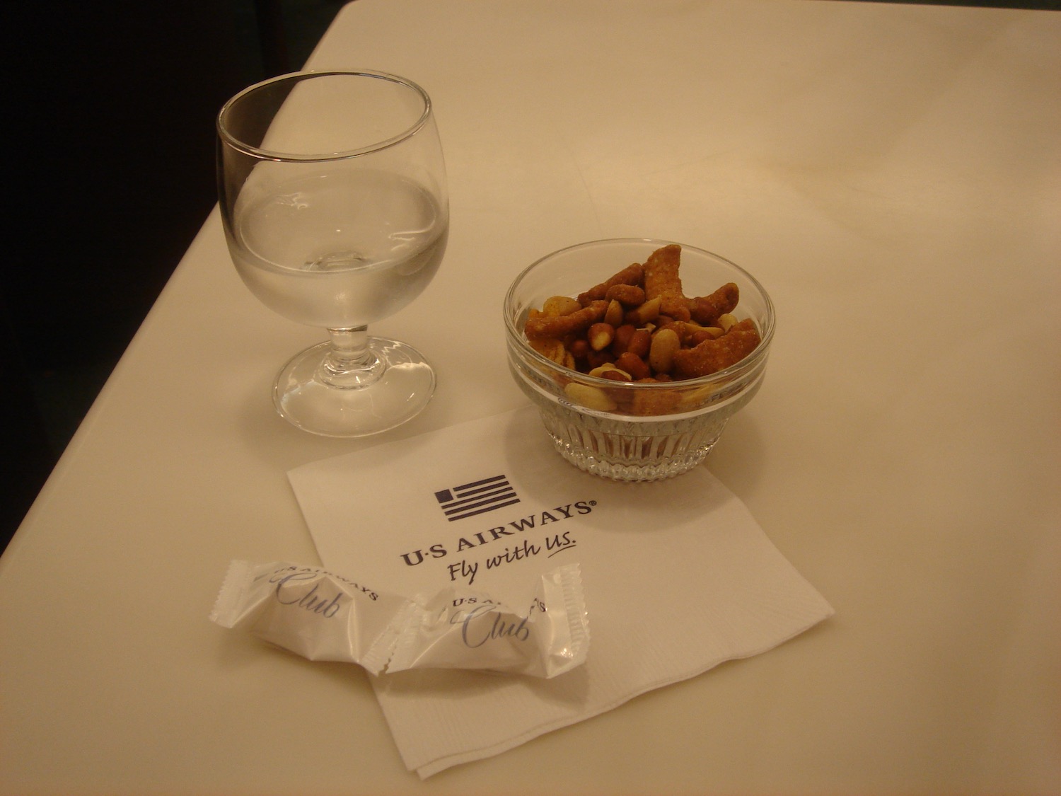 a bowl of nuts and a glass of water