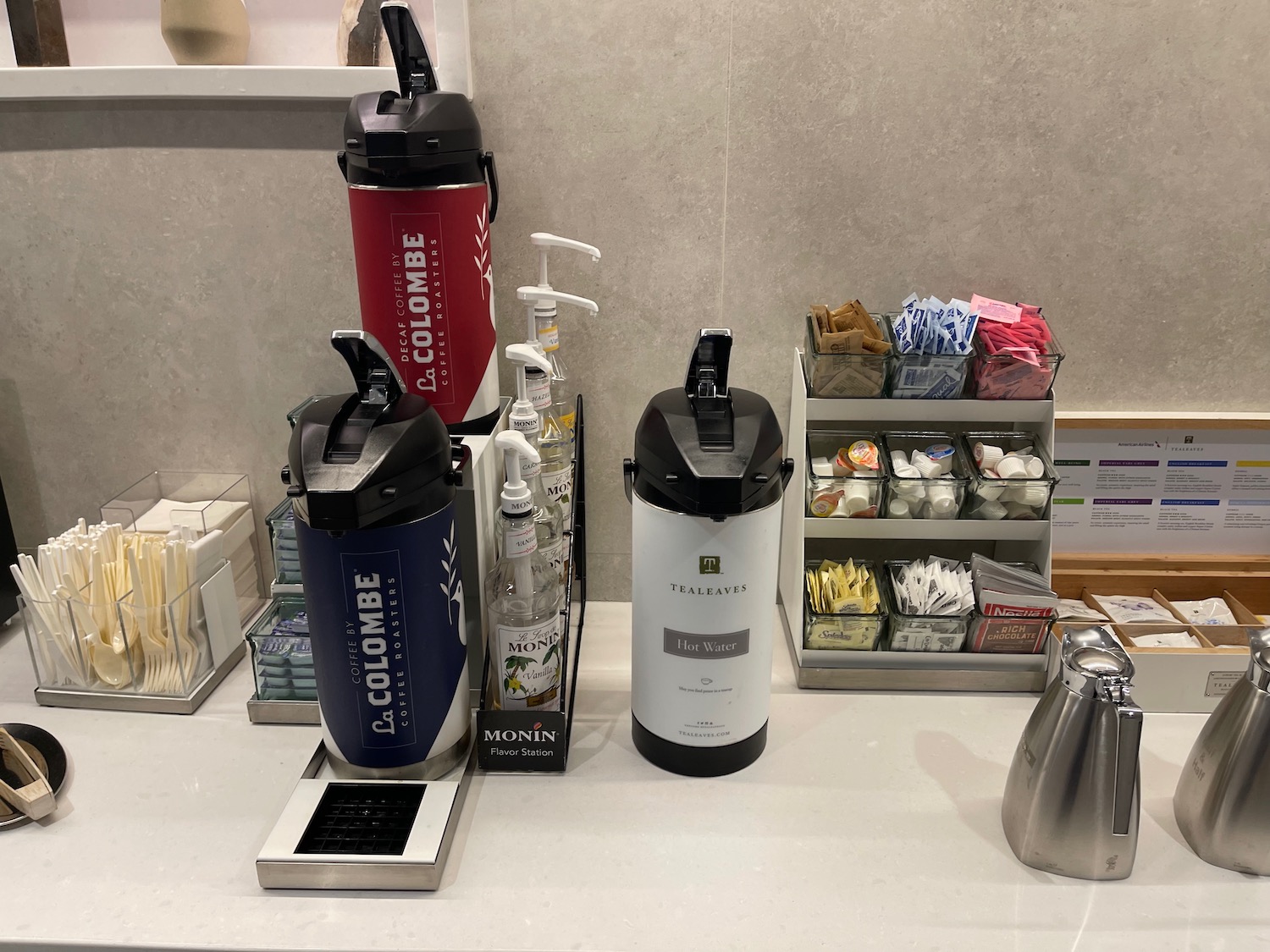 a coffee maker and other coffee items on a counter