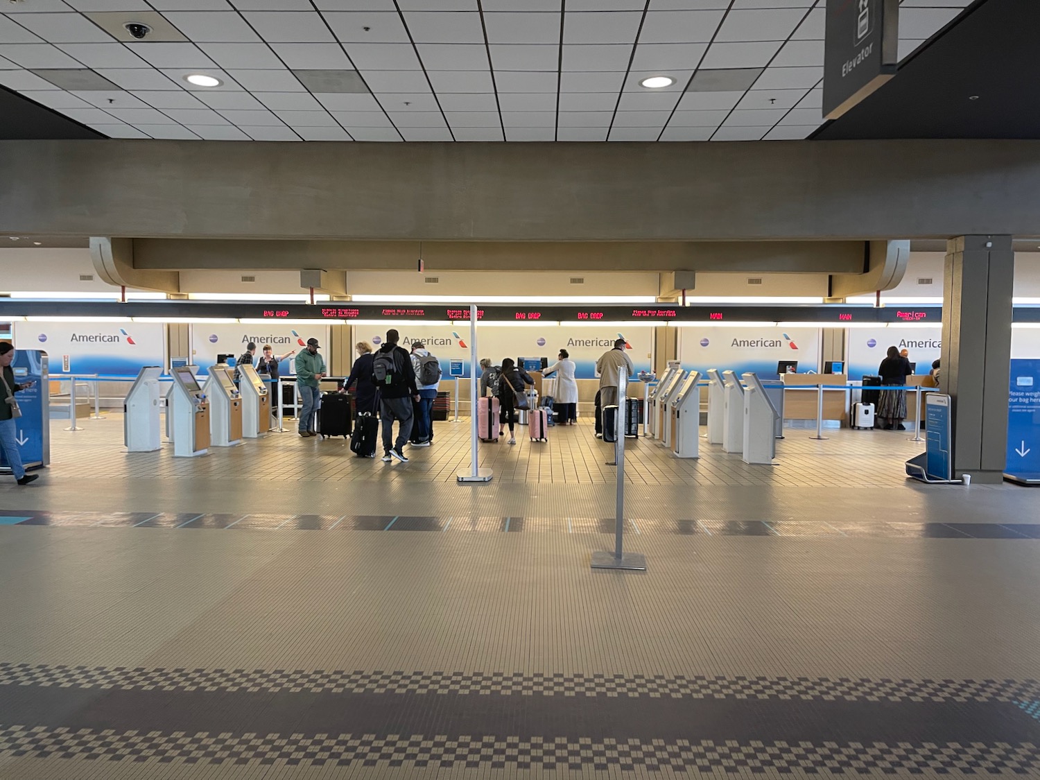 people standing in a line at an airport