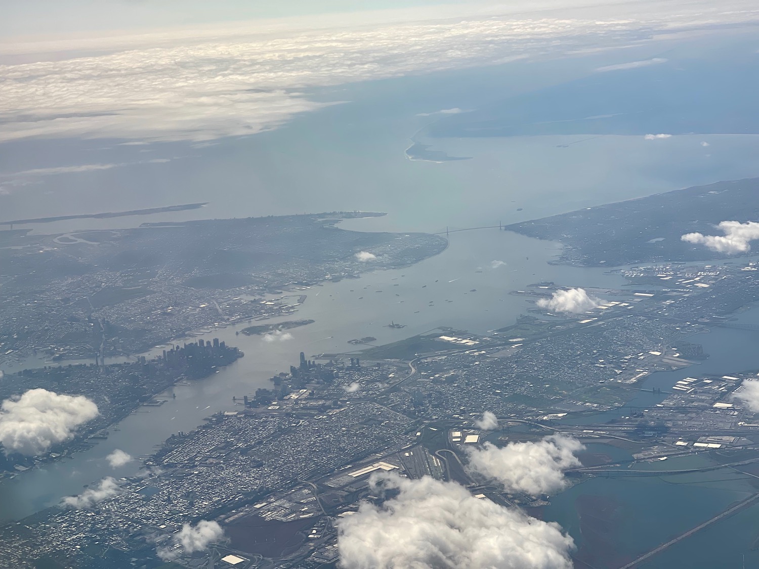 aerial view of a city and water from an airplane