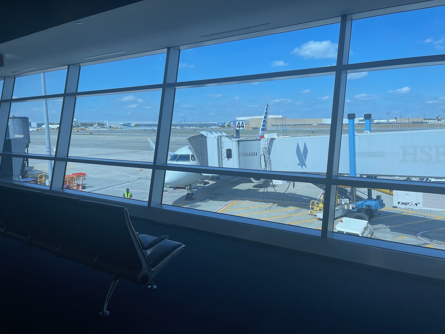 a window with a seat and a plane in the background