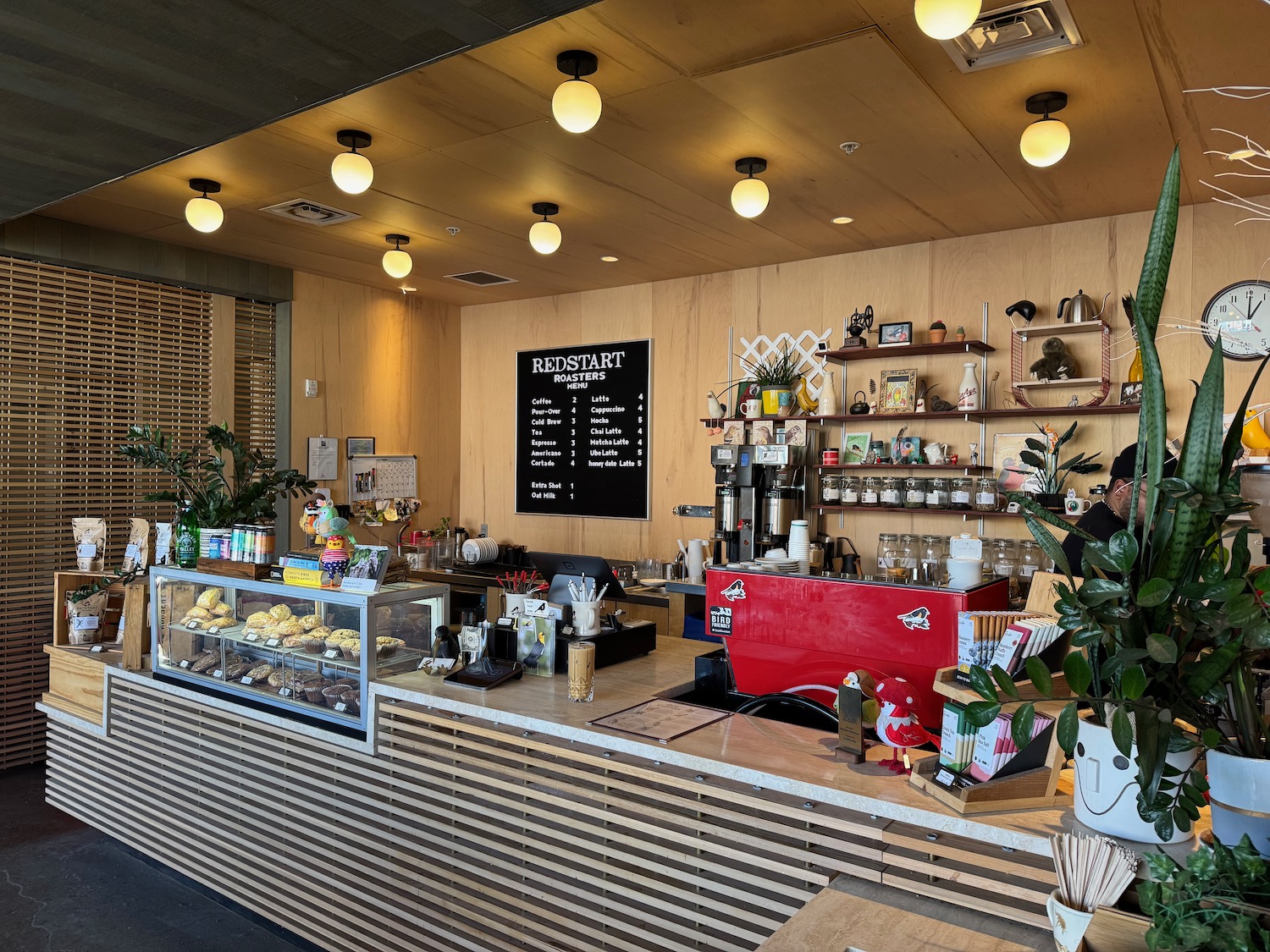 a coffee shop with a counter and a display case