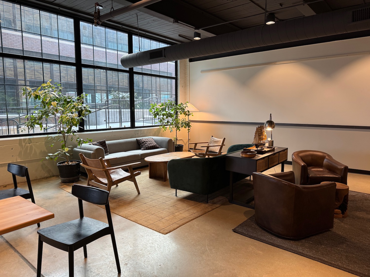a room with a large window and a couch and a table