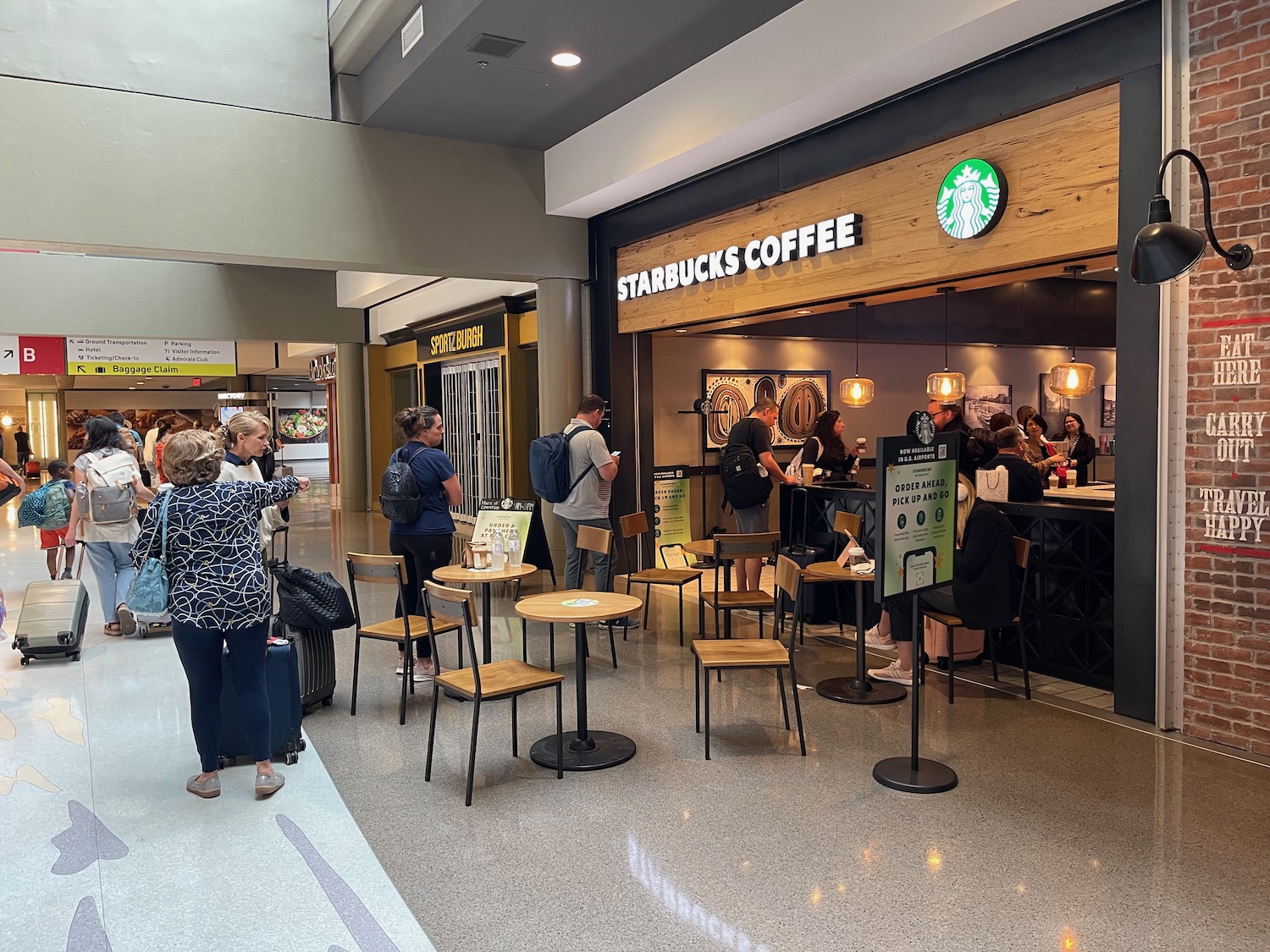 people standing in a line at a coffee shop