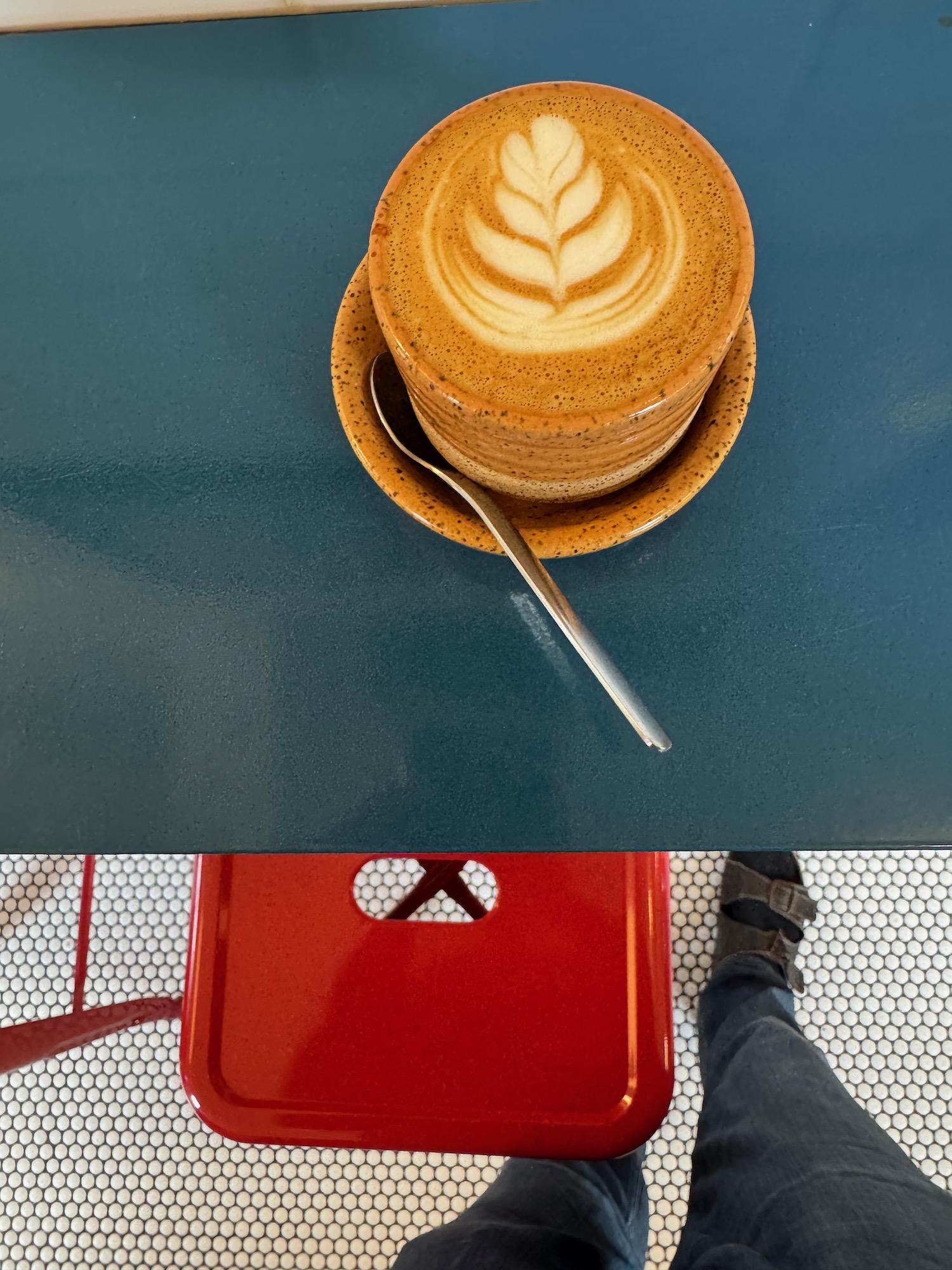 a stack of latte art on a plate with a spoon