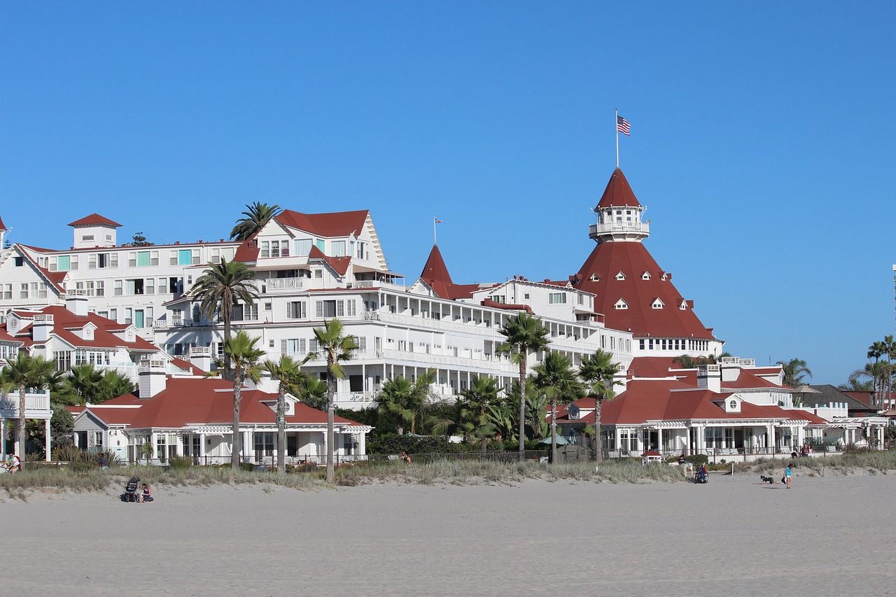 a large white building with red roofs and a flag on top