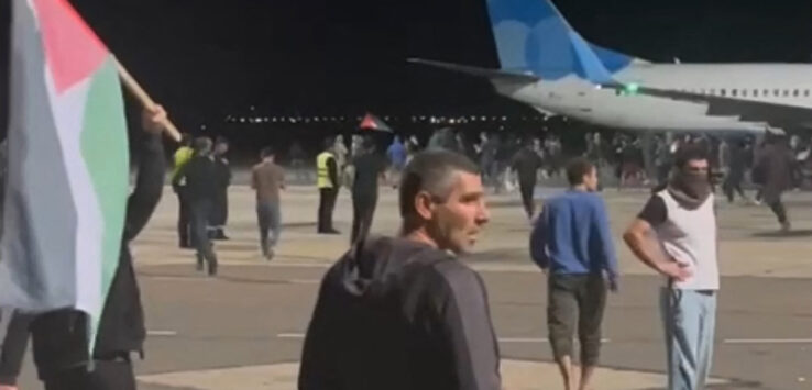 a group of people walking around a plane