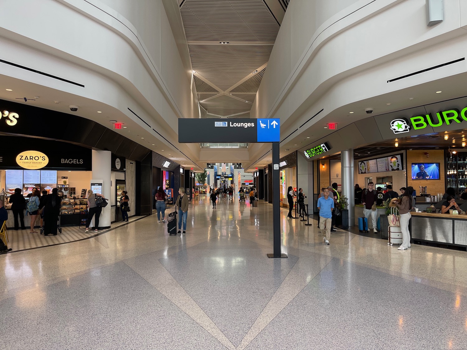 a group of people walking in a large airport