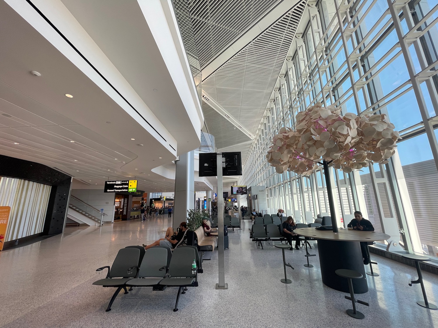 a group of people sitting in a large airport terminal