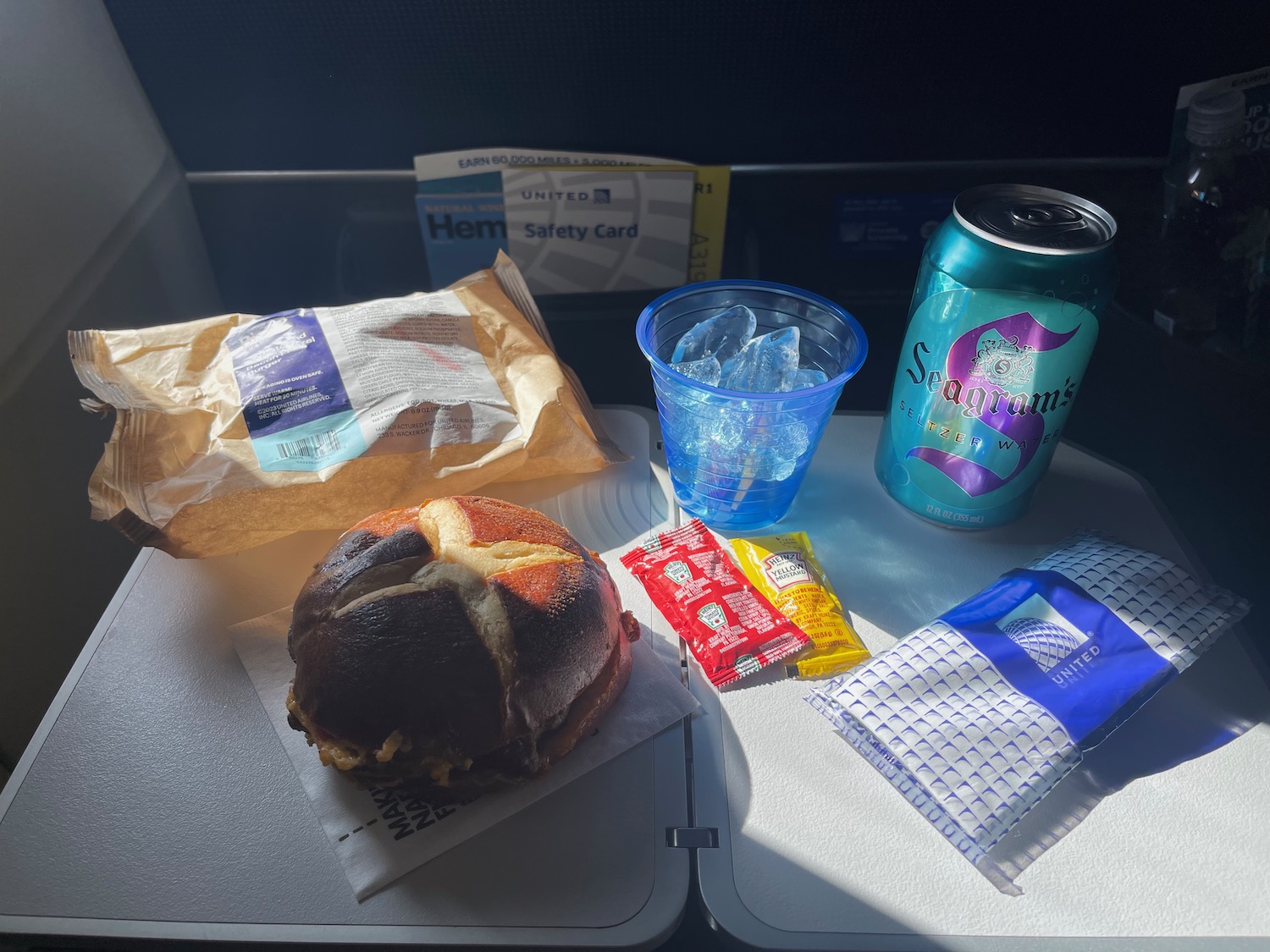 food on a tray with drinks and a sandwich