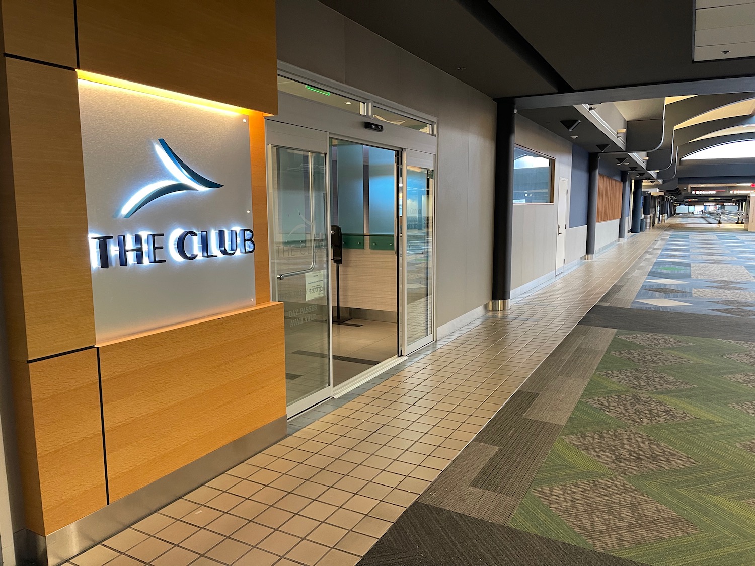 a hallway with a sign and glass doors