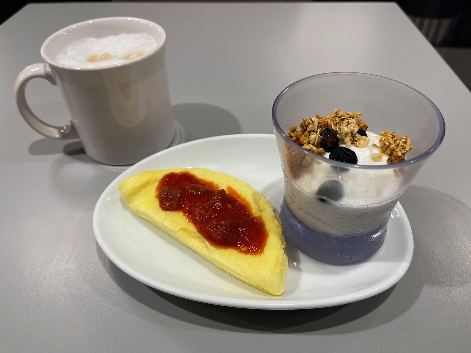 a plate of food and a cup of coffee