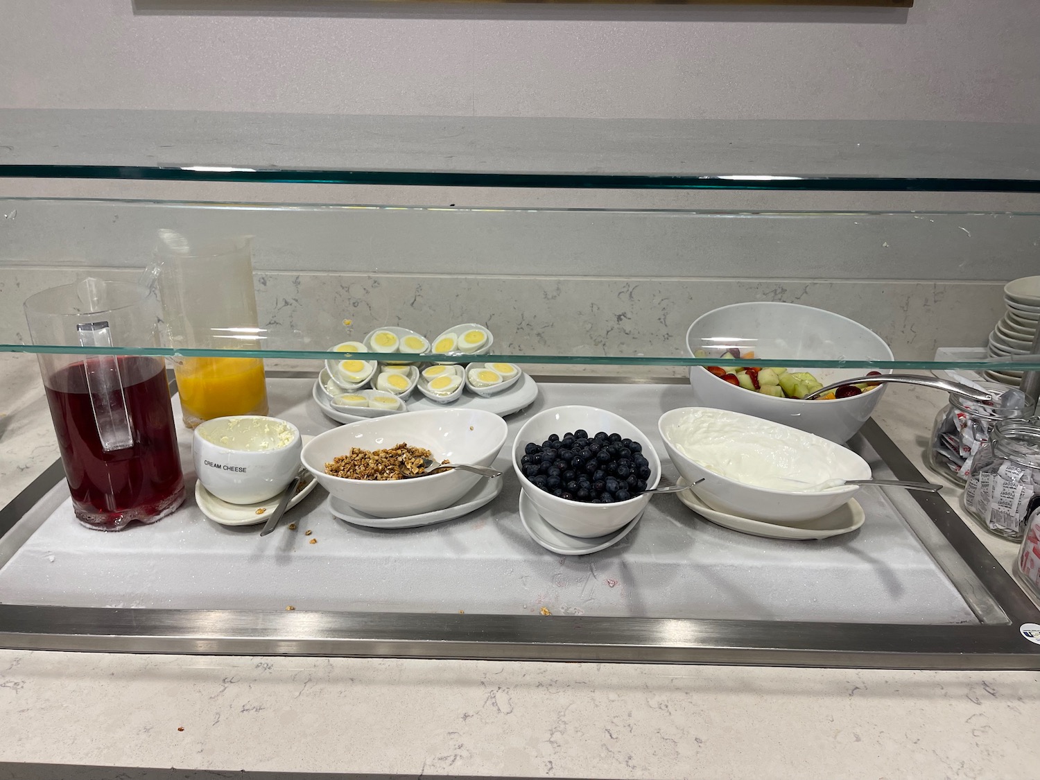 a glass display case with food on it