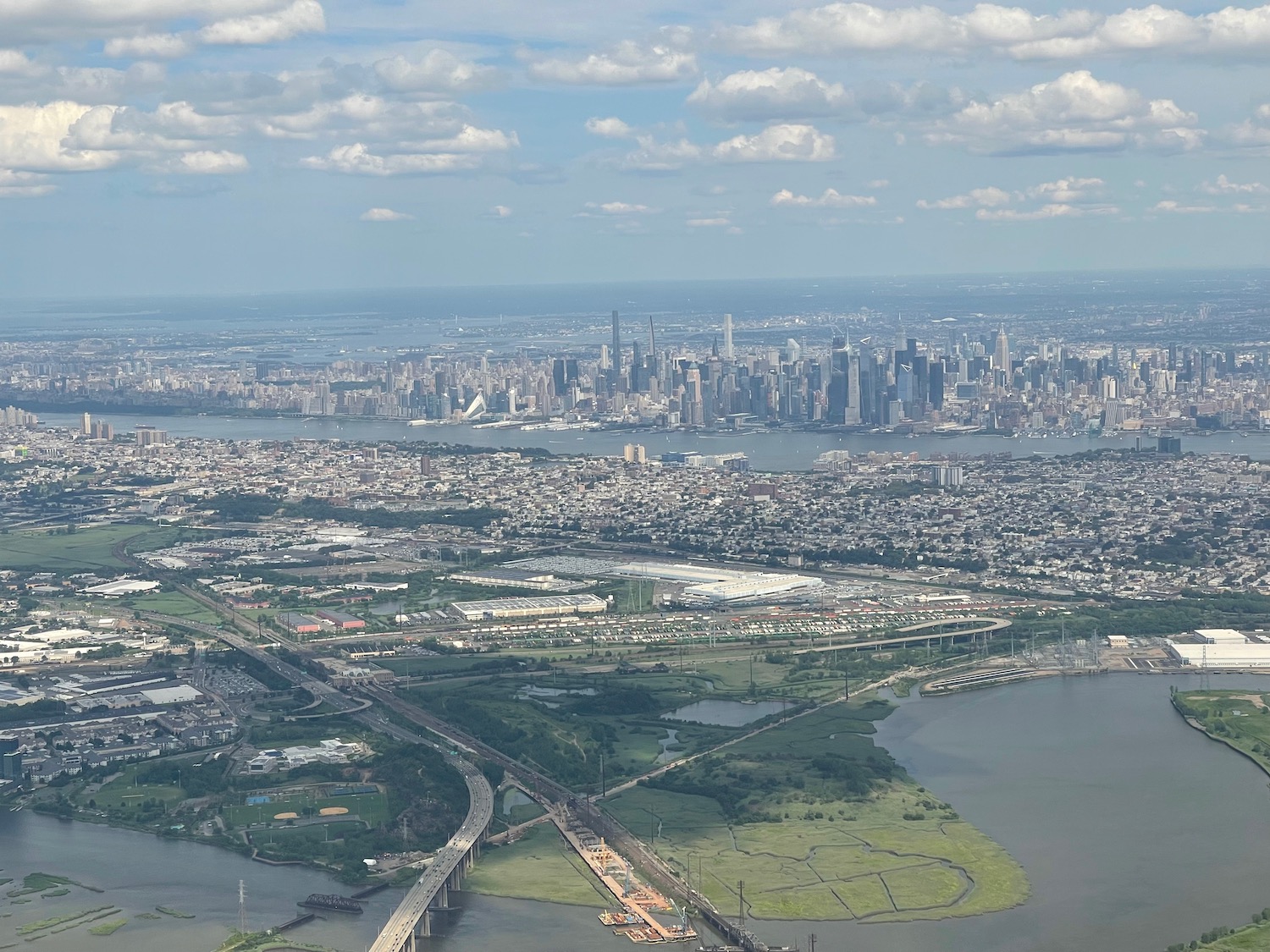 a cityscape with a bridge and a body of water