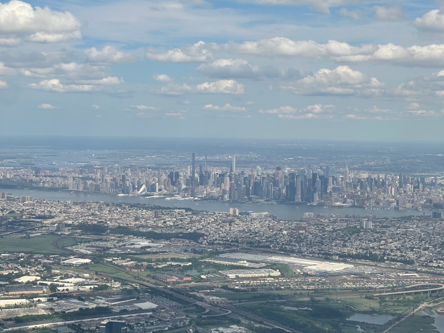 a city with a body of water and a city in the distance