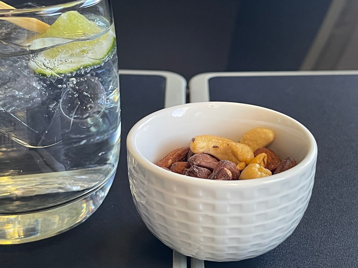 a bowl of nuts and a glass of water