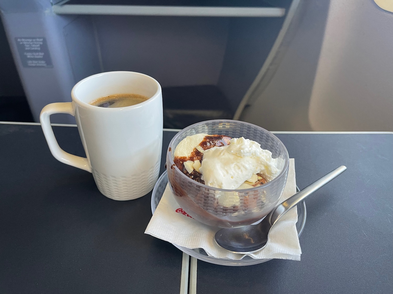 a cup of coffee and ice cream on a plate