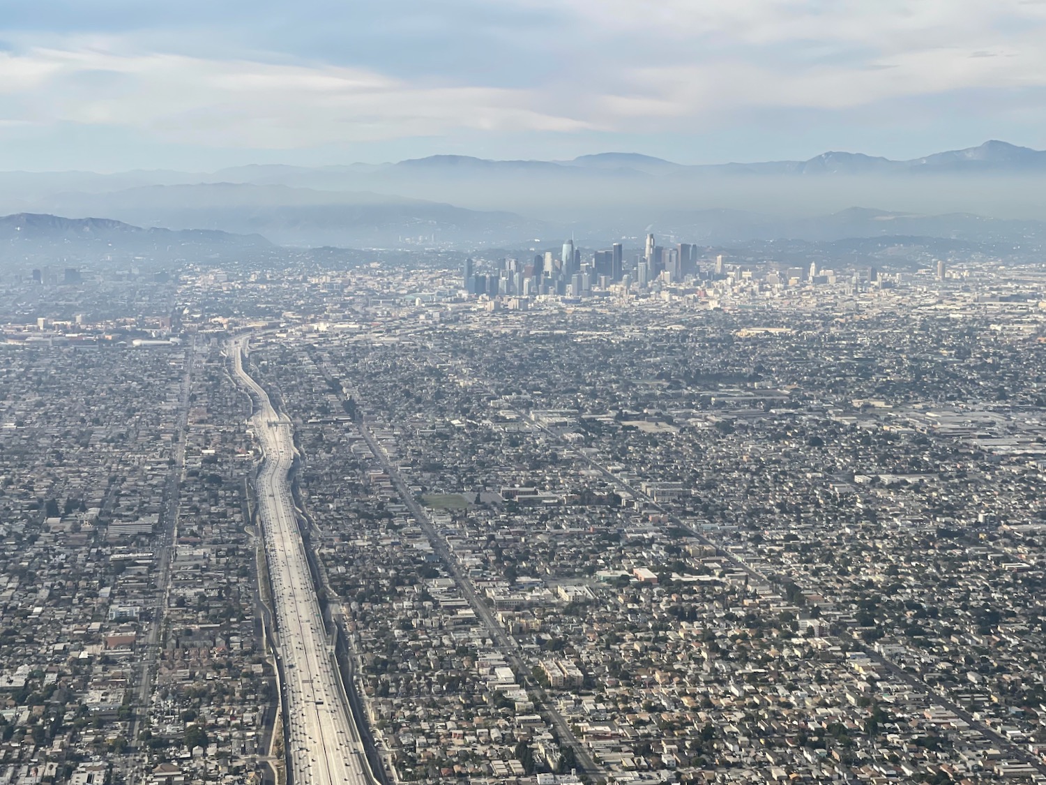 a city with a road and a city in the distance